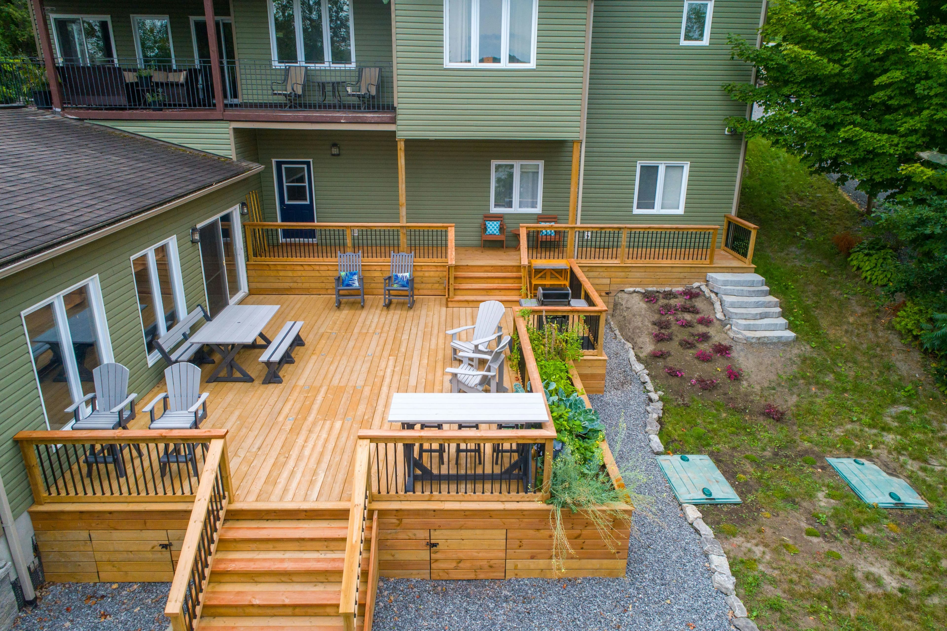 The completed multi-level cedar deck with black railings