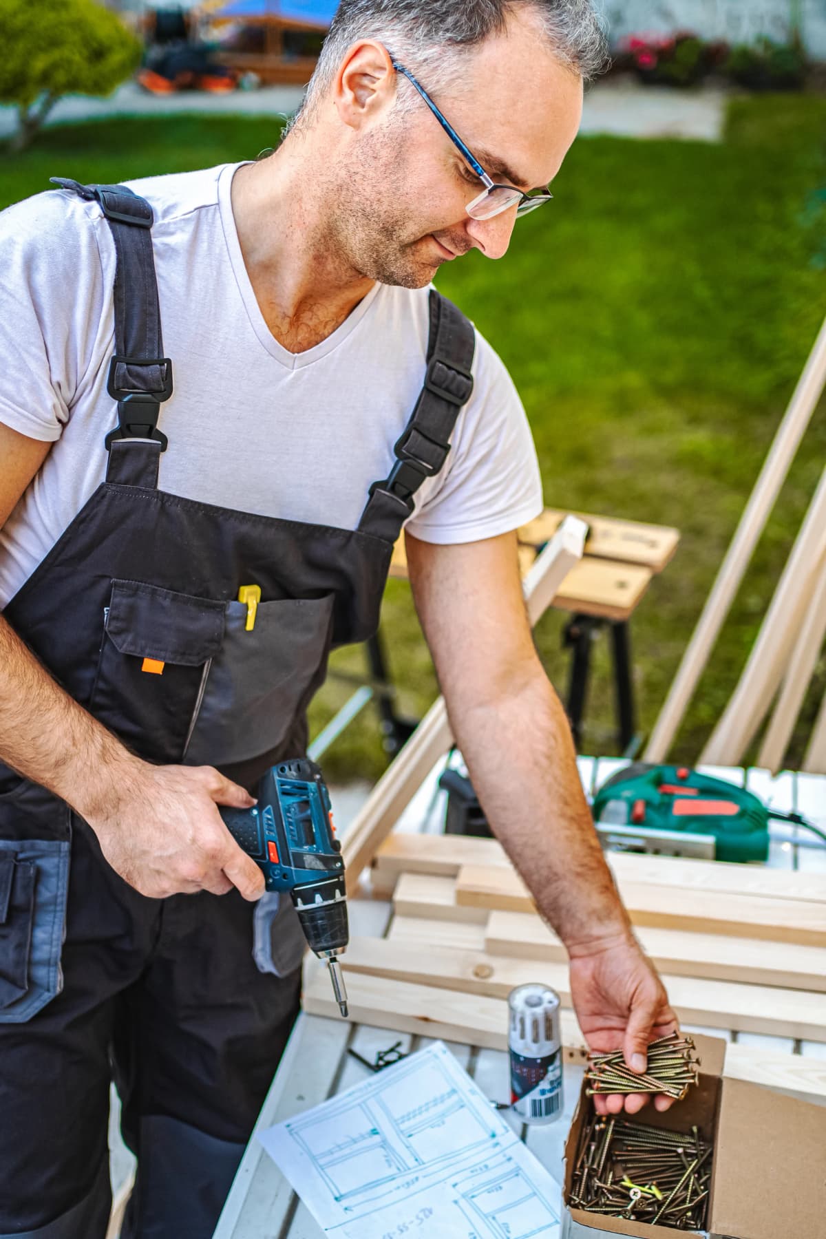 A professional handyman carefully hanging a large piece of art.